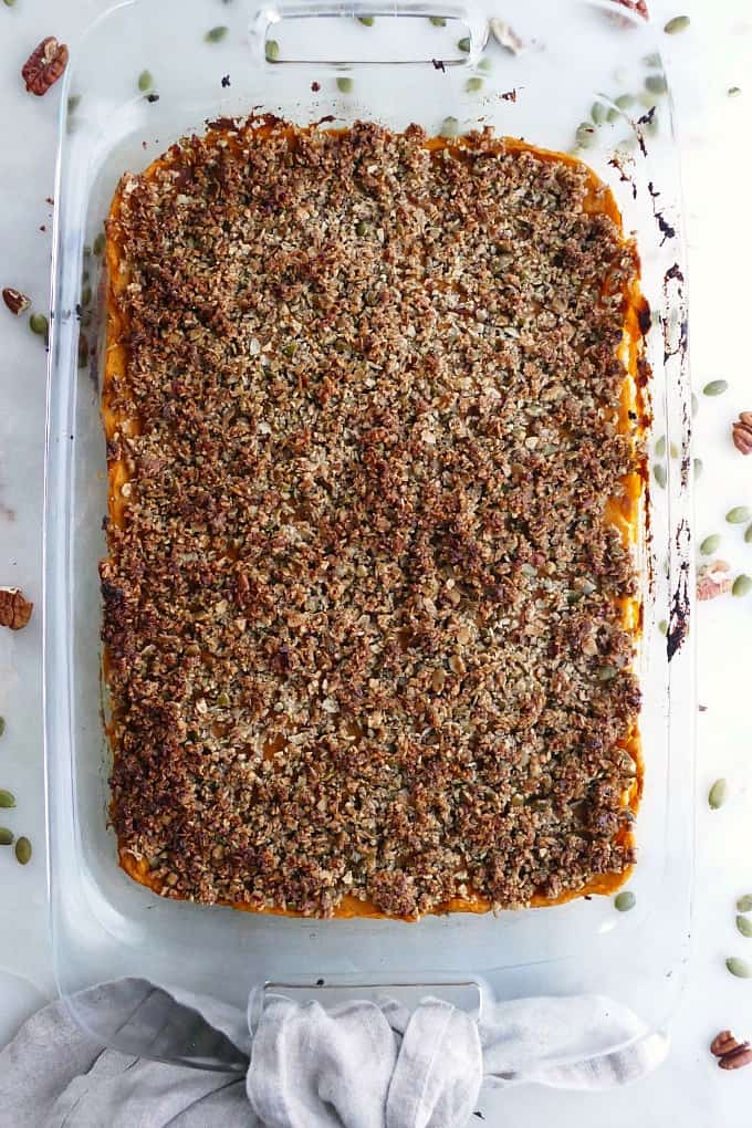 finished sweet potato casserole on a white counter with a grey napkin