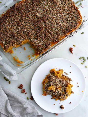 dish with gluten free sweet potato casserole next to a plate with a serving of it