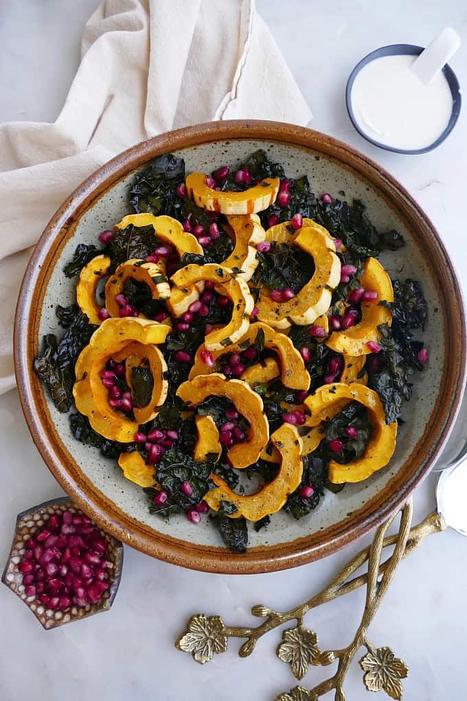 roasted delicata squash and kale without dressing in a large bowl on counter