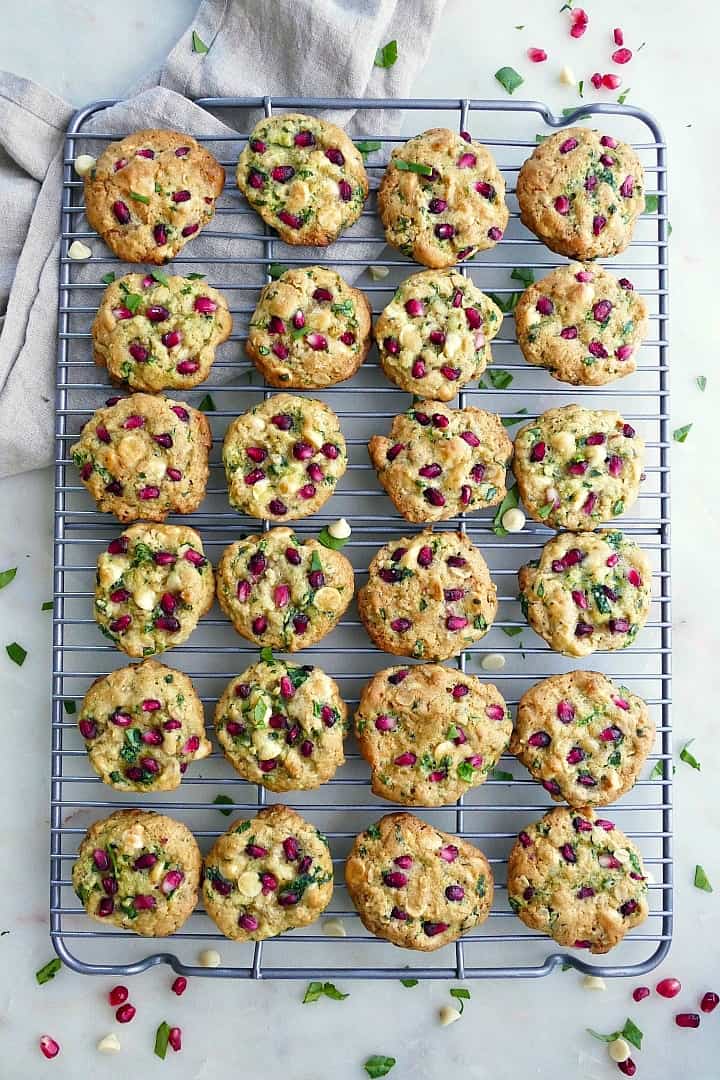 two dozen white chocolate chip spinach cookies on a wire cooling rack