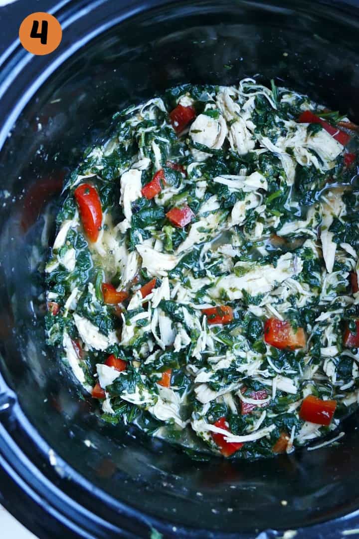 shredded mexican chicken with spinach and chopped bell pepper in a crockpot