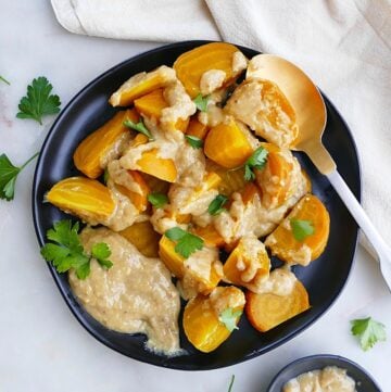 roasted golden beets on a black plate with miso maple sauce