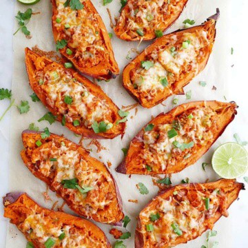 8 sweet potato skins on a white counter with cilantro and limes