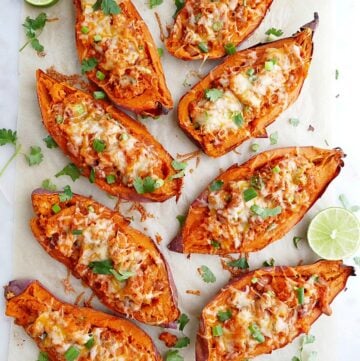 8 sweet potato skins on a white counter with cilantro and limes