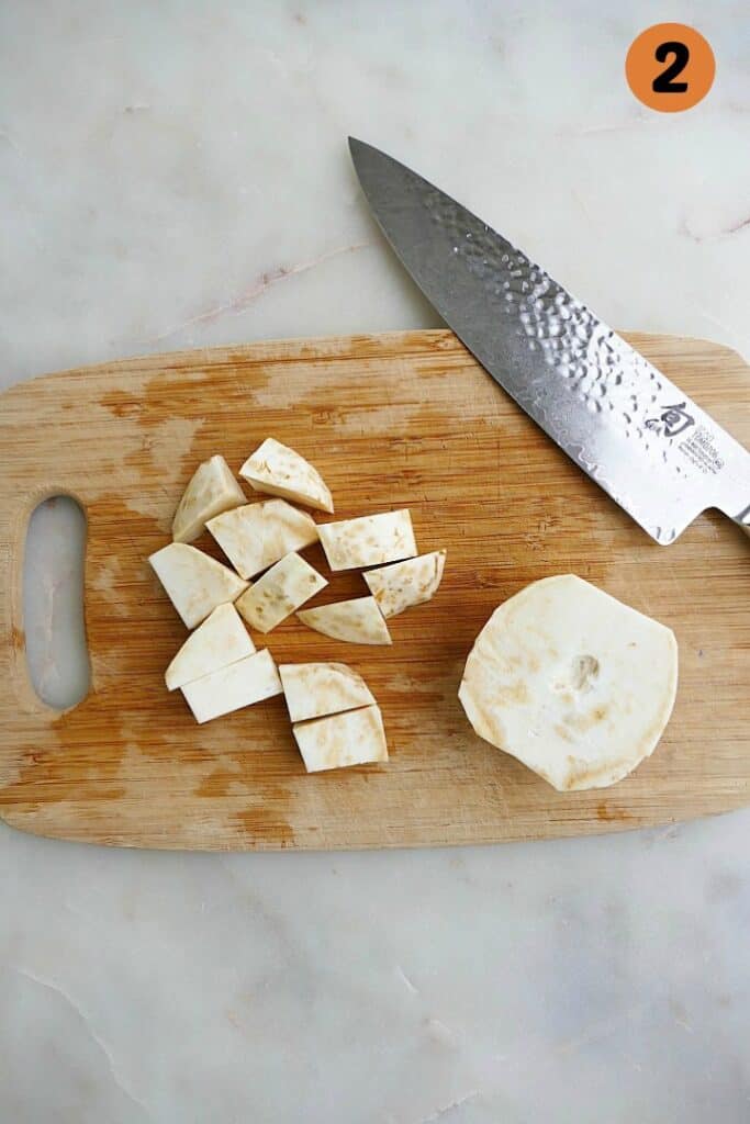 cut celery root on a cutting board with a knife and the number 2 in the corner