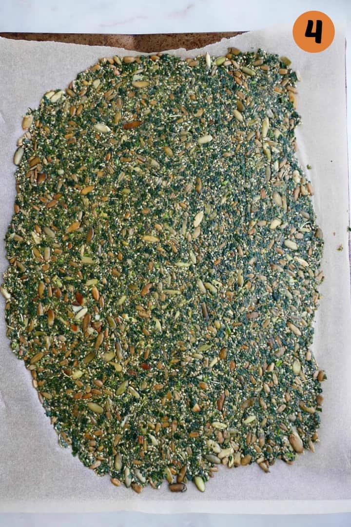 4 kale crackers stacked on top of each other on a white counter