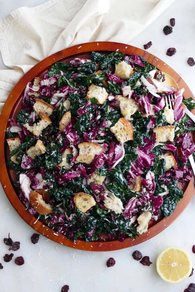 kale radicchio salad with sourdough croutons on a large wooden platter