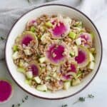 watermelon radish salad with thyme in a white bowl on a counter