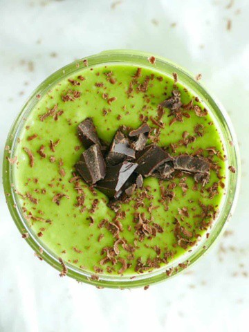 green drink in a glass with shaved chocolate on top