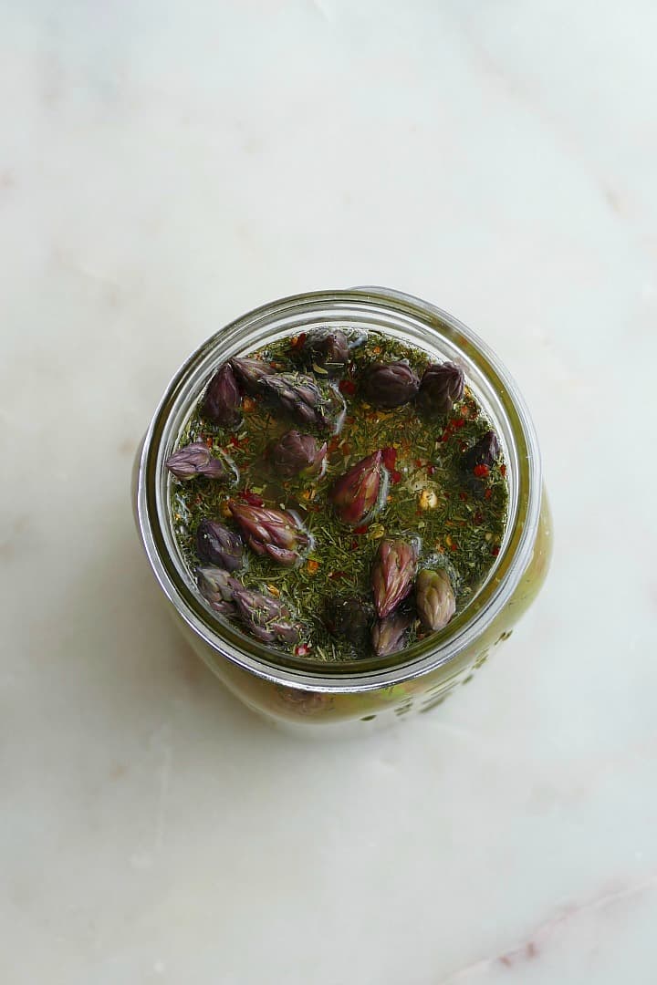 overhead shot of asparagus in a jar with pickle brine and dill