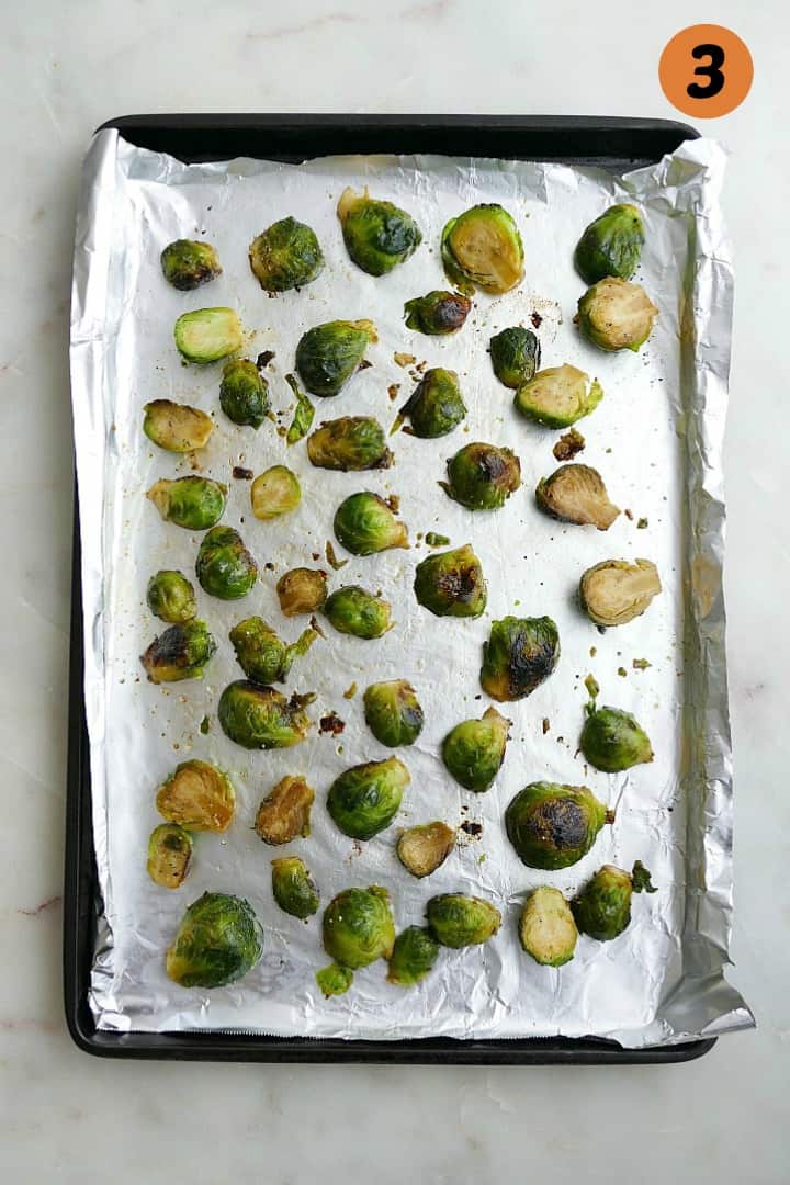 cooked veggies on a baking sheet lined with aluminum foil