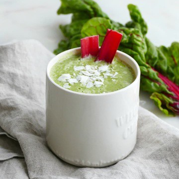 side view of finished smoothie topped with coconut and chard stems