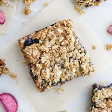 blueberry rhubarb crumb bars spread out on a counter