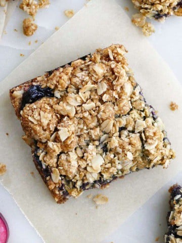 square image of a blueberry rhubarb crisp bar on a counter