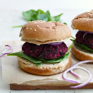 black bean beet burger on a seeded whole wheat bun with lettuce, onion, and mayo