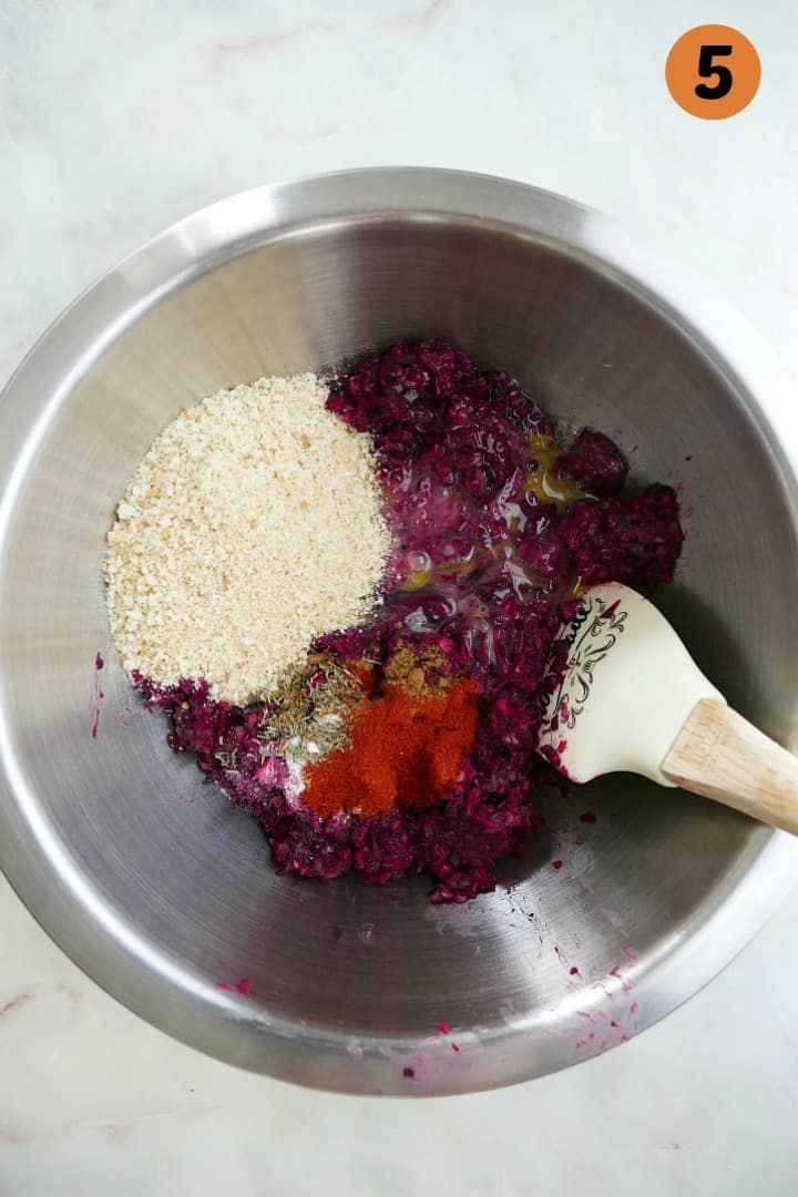 beets, black beans, breadcrumbs, eggs, and seasonings in a silver mixing bowl