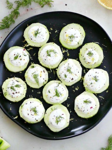 square image of cucumber canapes topped with whipped feta and dill