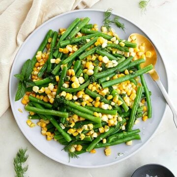 green beans and corn with herbs on a serving plate
