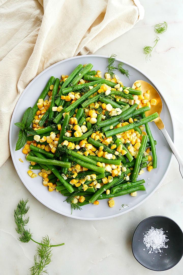 green beans and corn with herbs on a serving plate