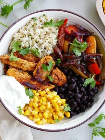 square image of chicken fajita bowl with toppings on a counter