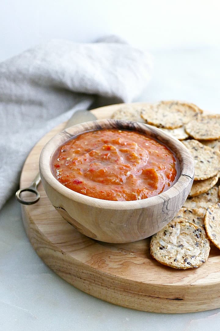 side view of eggplant red pepper dip on a serving platter