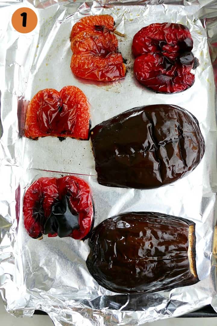 blistered red peppers and eggplants on a baking sheet with the number 1 in the corner