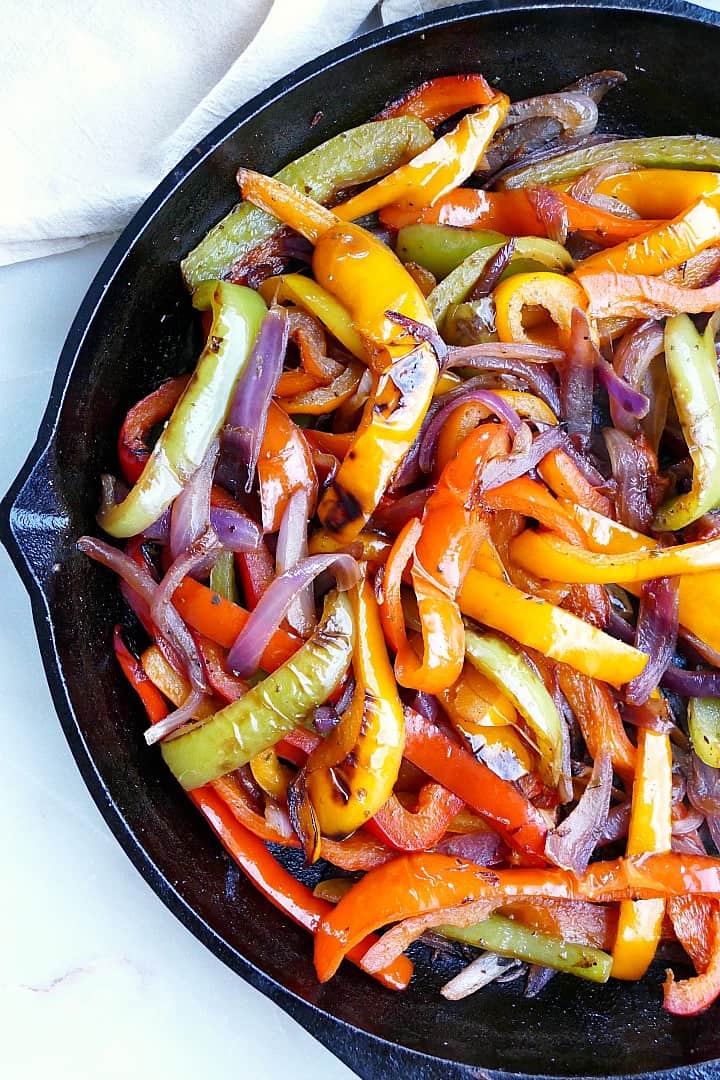 close shot of fajita peppers and onions in a cast iron skillet