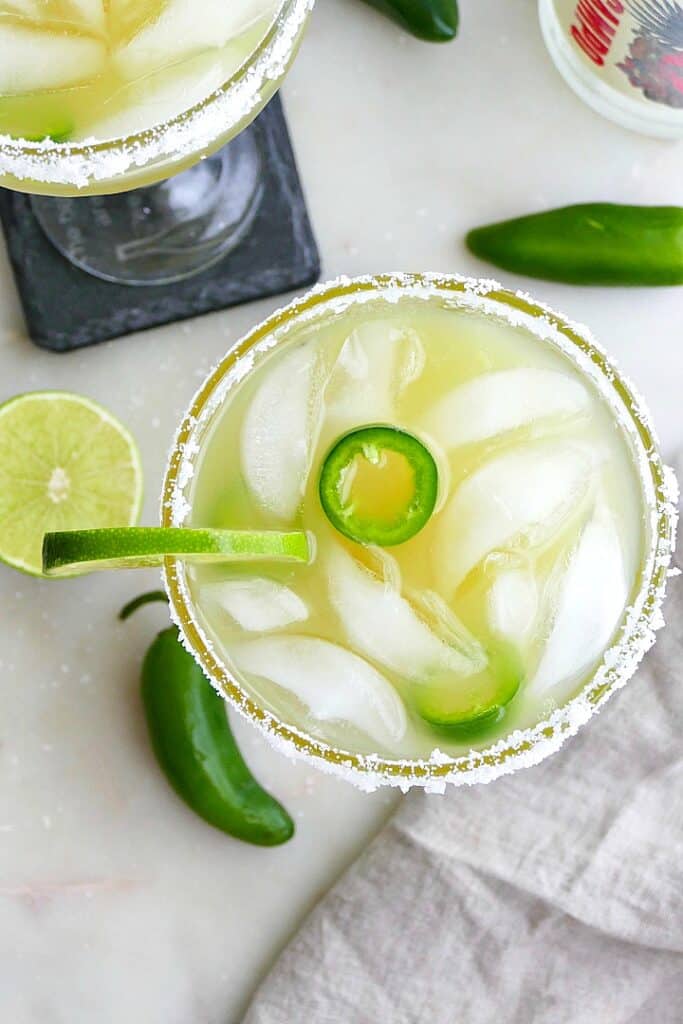 overhead shot of a margarita with jalapeno and lime slices