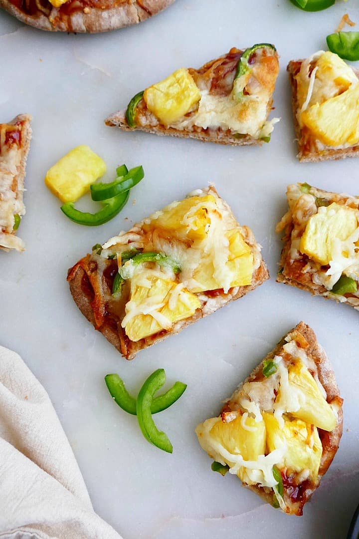 slices of pineapple jalapeno pizza next to each other on a counter