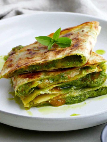 square image of spinach basil pesto quesadillas on a plate