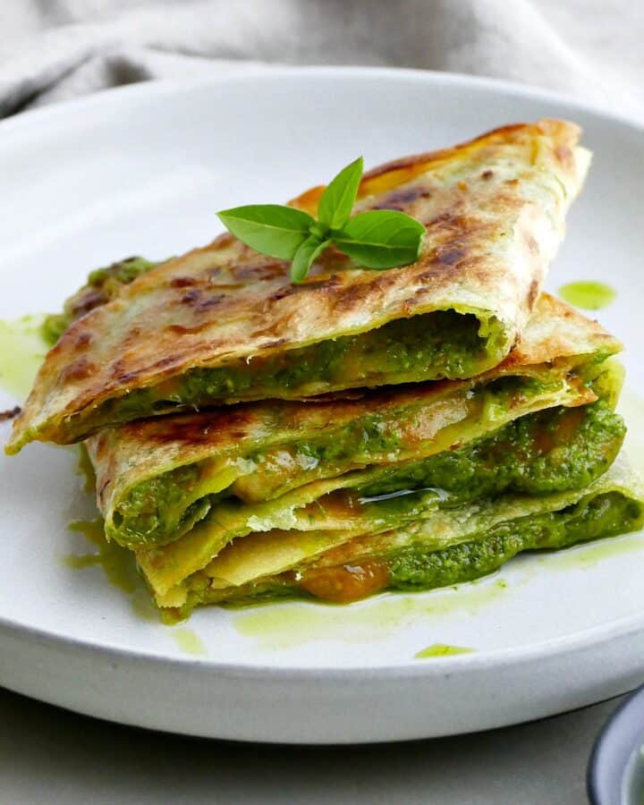 square image of spinach basil pesto quesadillas on a plate