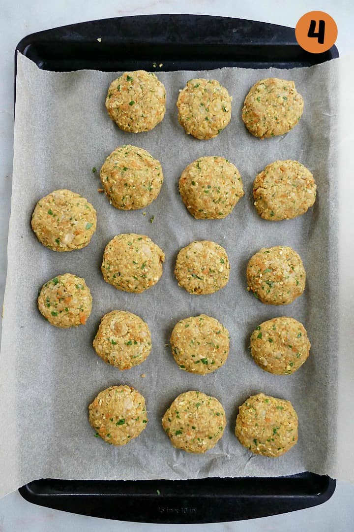 17 carrot falafel patties on a baking sheet with the number four in the corner