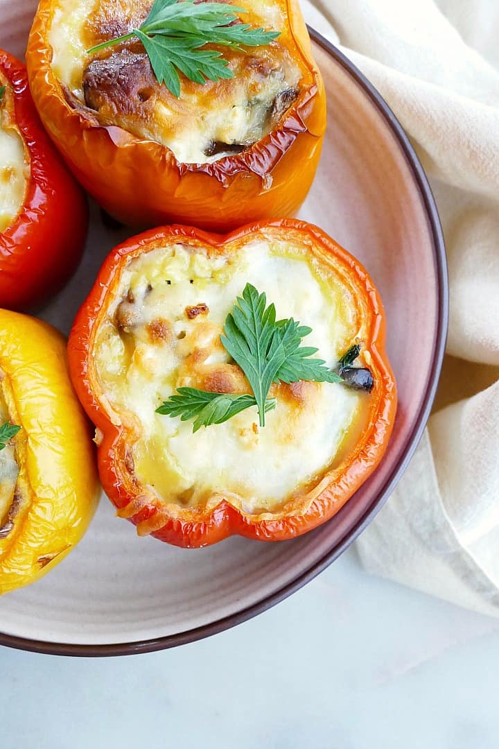 close-up image of a breakfast stuffed pepper with parsley on a serving platter