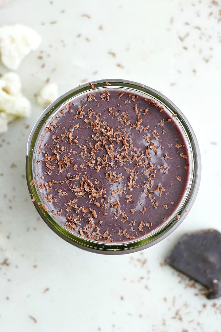 above view of cherry chocolate cauliflower smoothie with shaved chocolate on a counter