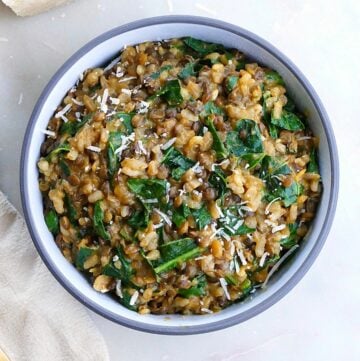 lentil risotto with collards in a serving bowl on a counter