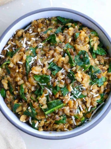 square image of lentil risotto with collard greens on a counter