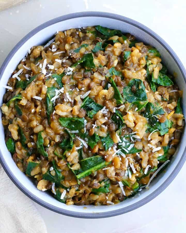square image of lentil risotto with collard greens on a counter