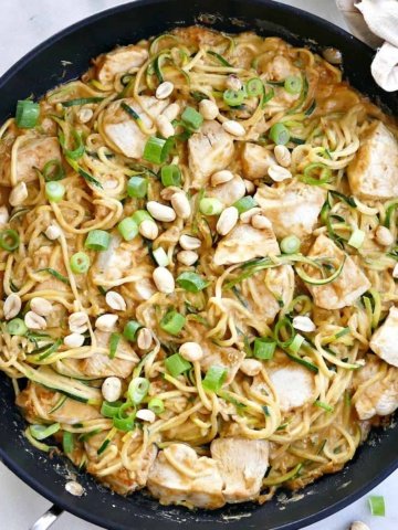 square image of peanut zucchini noodles with chicken in a skillet