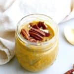 pumpkin chia pudding in a jar with pecans on top, next to a napkin