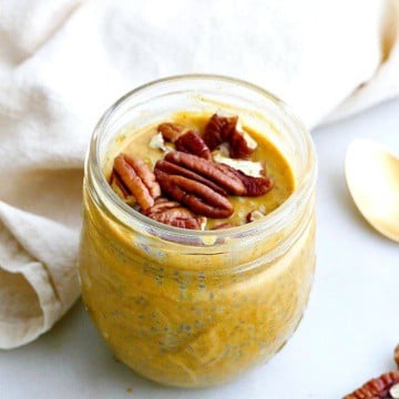 pumpkin chia pudding in a jar with pecans on top, next to a napkin