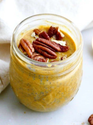 square image of pumpkin chia pudding with pecans in front of a napkin