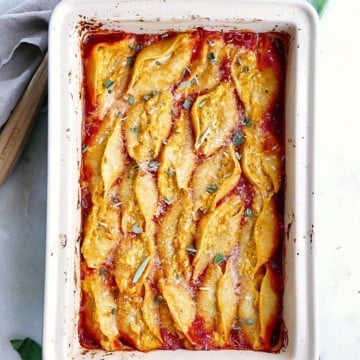 finished ricotta and pumpkin stuffed shells in a large baking dish on a counter