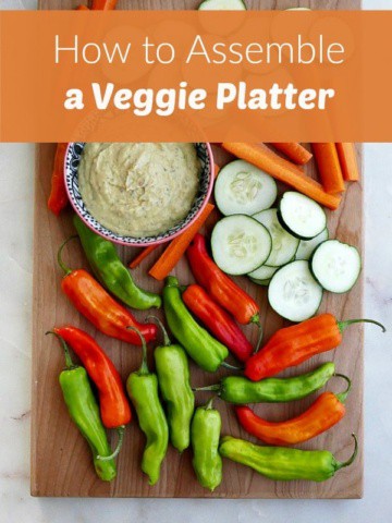 veggies on dip on a wooden board with a text box overlay