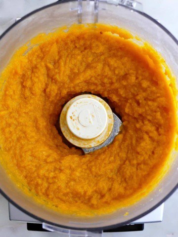 square image of butternut squash puree in a food processor on a counter