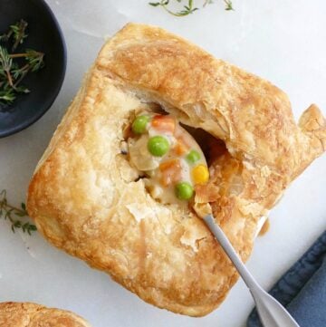 mini vegetarian pot pie with a small spoon with filling in the center