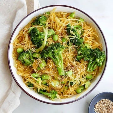 spaghetti squash stir fry with edamame and broccoli in a serving bowl on a counter