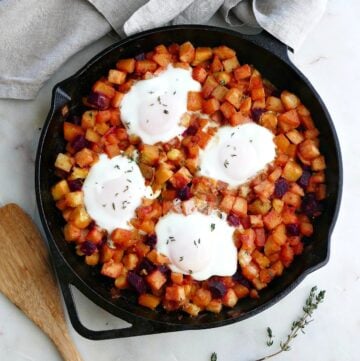 root vegetable has in a skillet topped with four eggs on a counter