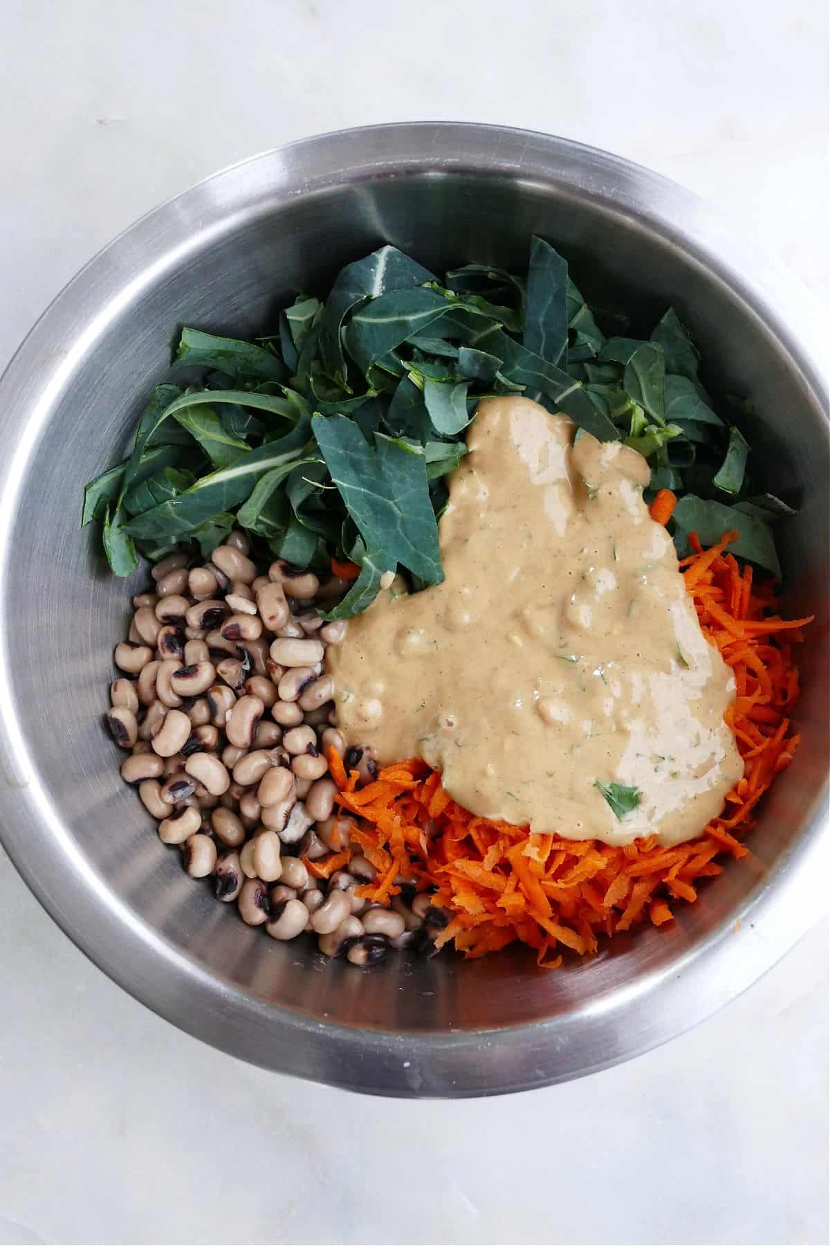 ingredients for collard greens salad with peanut sauce in a mixing bowl