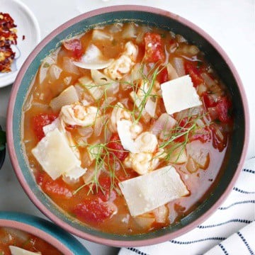 bowl of fennel stew with shrimp in a soup bowl with toppings