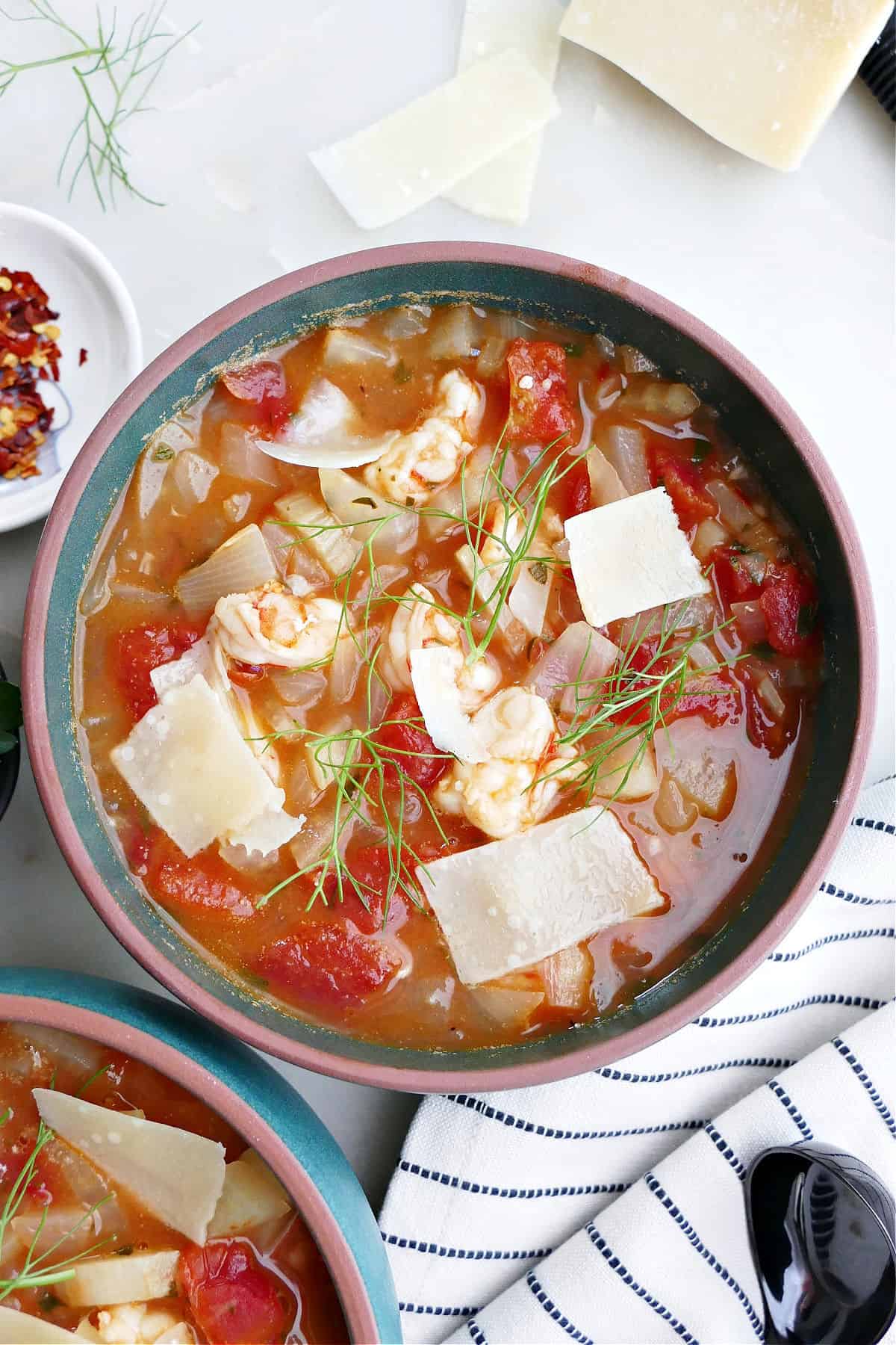 bowl of fennel stew with shrimp in a soup bowl with toppings